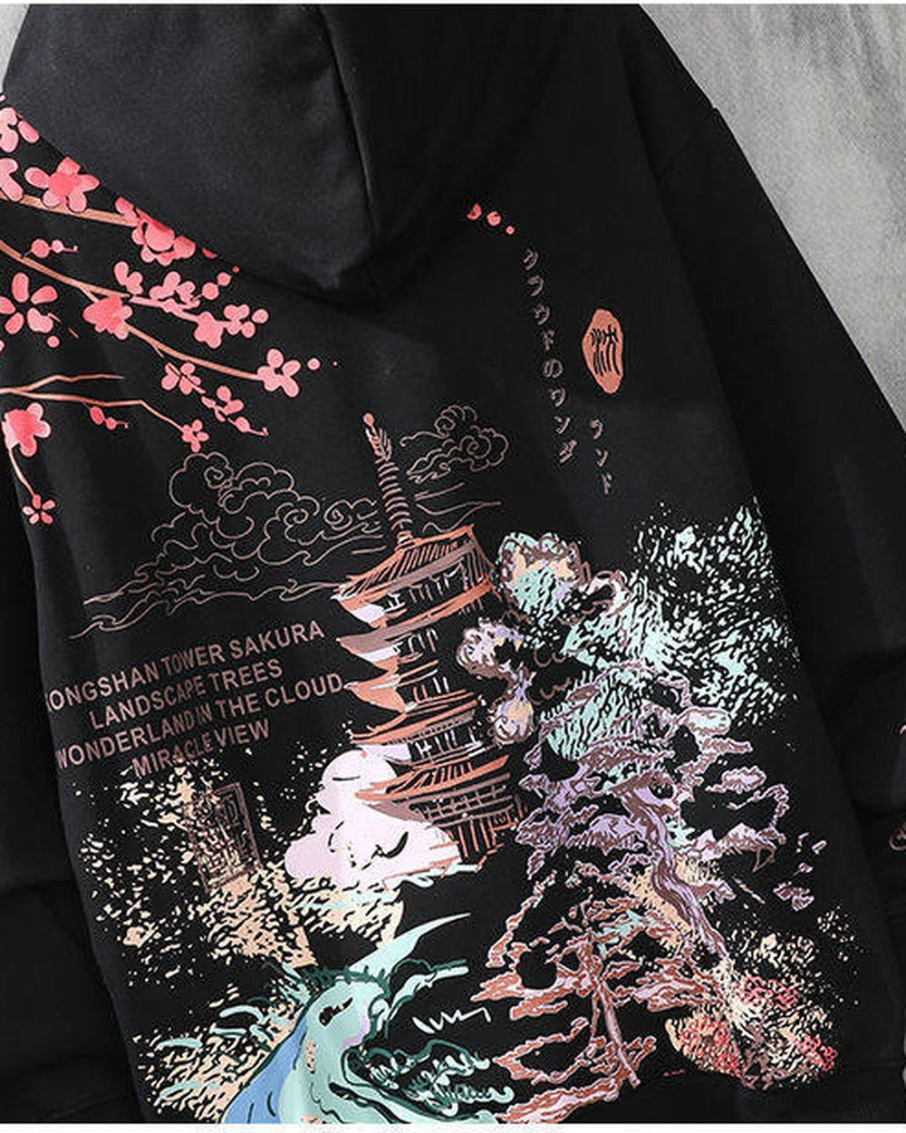 Close-up of the printed pagoda, cherry blossoms and waves on the black hoodie