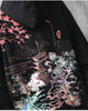 Close-up of the printed pagoda, cherry blossoms and waves on the black hoodie