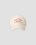 Beige washed dad cap with pink script embroidery, front view