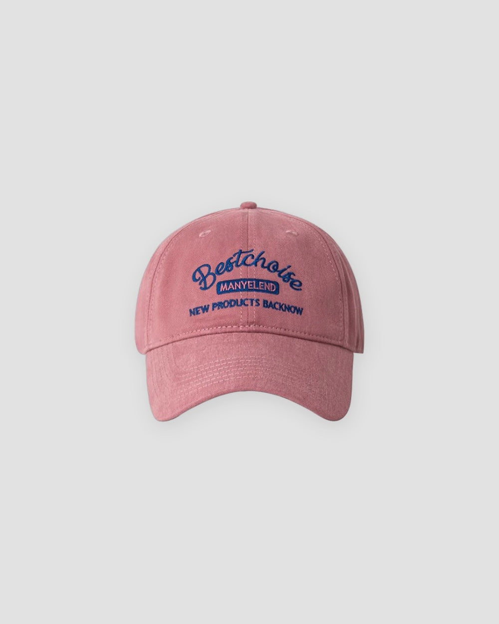 Pink washed dad cap with navy script embroidery, front view