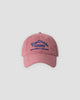Pink washed dad cap with navy script embroidery, front view