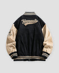 Black varsity jacket, back view, smaller script lettering on the upper back