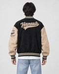Model wearing the black script letter varsity jacket, back view