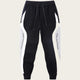 Black and white jogger pants with side stripes on a white background