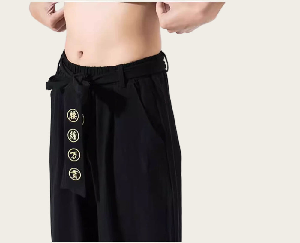 Black pants with gold buttons on a yellow background