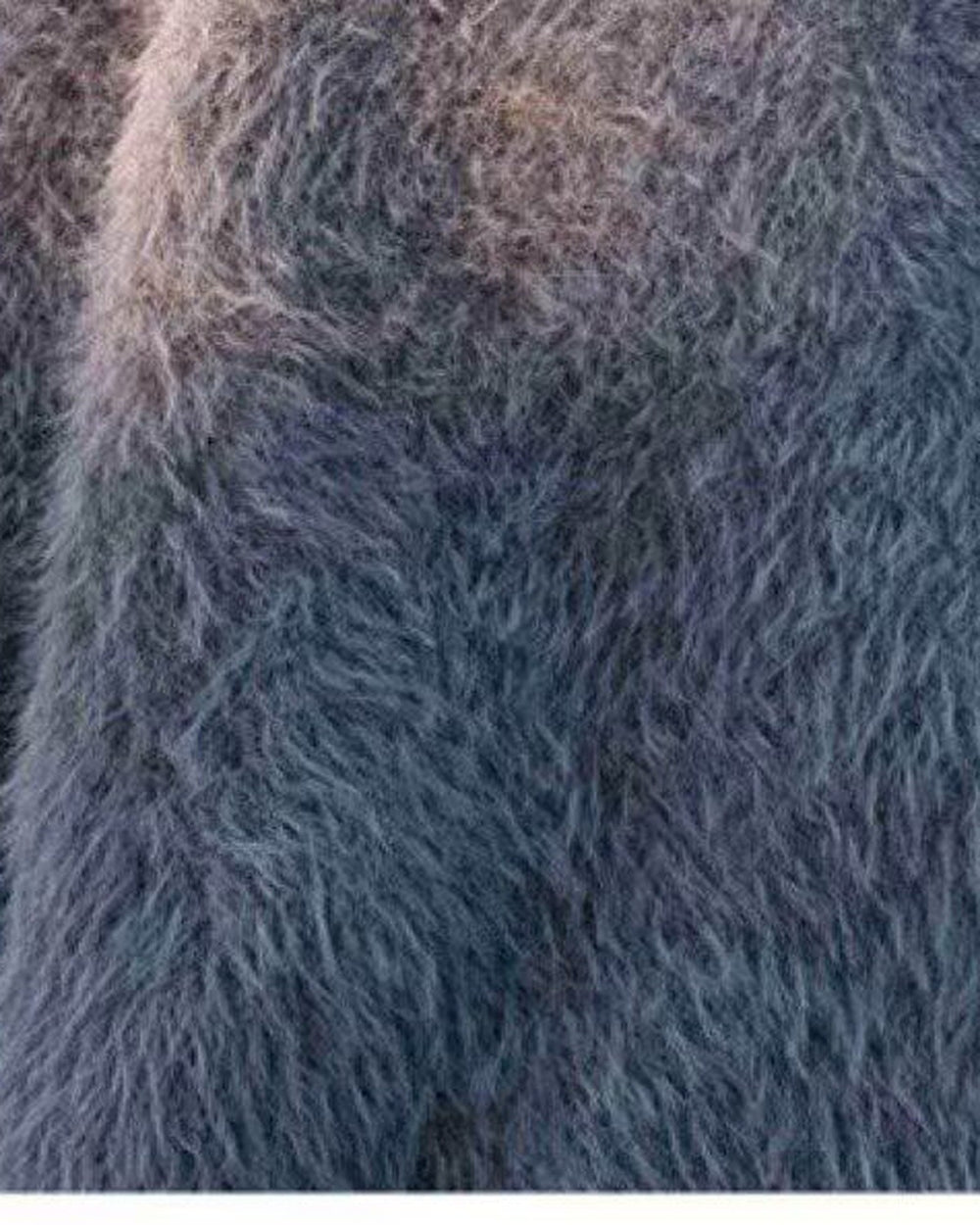 Close-up of the long, soft pile of the gray shaggy knit