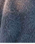 Close-up of the long, soft pile of the gray shaggy knit