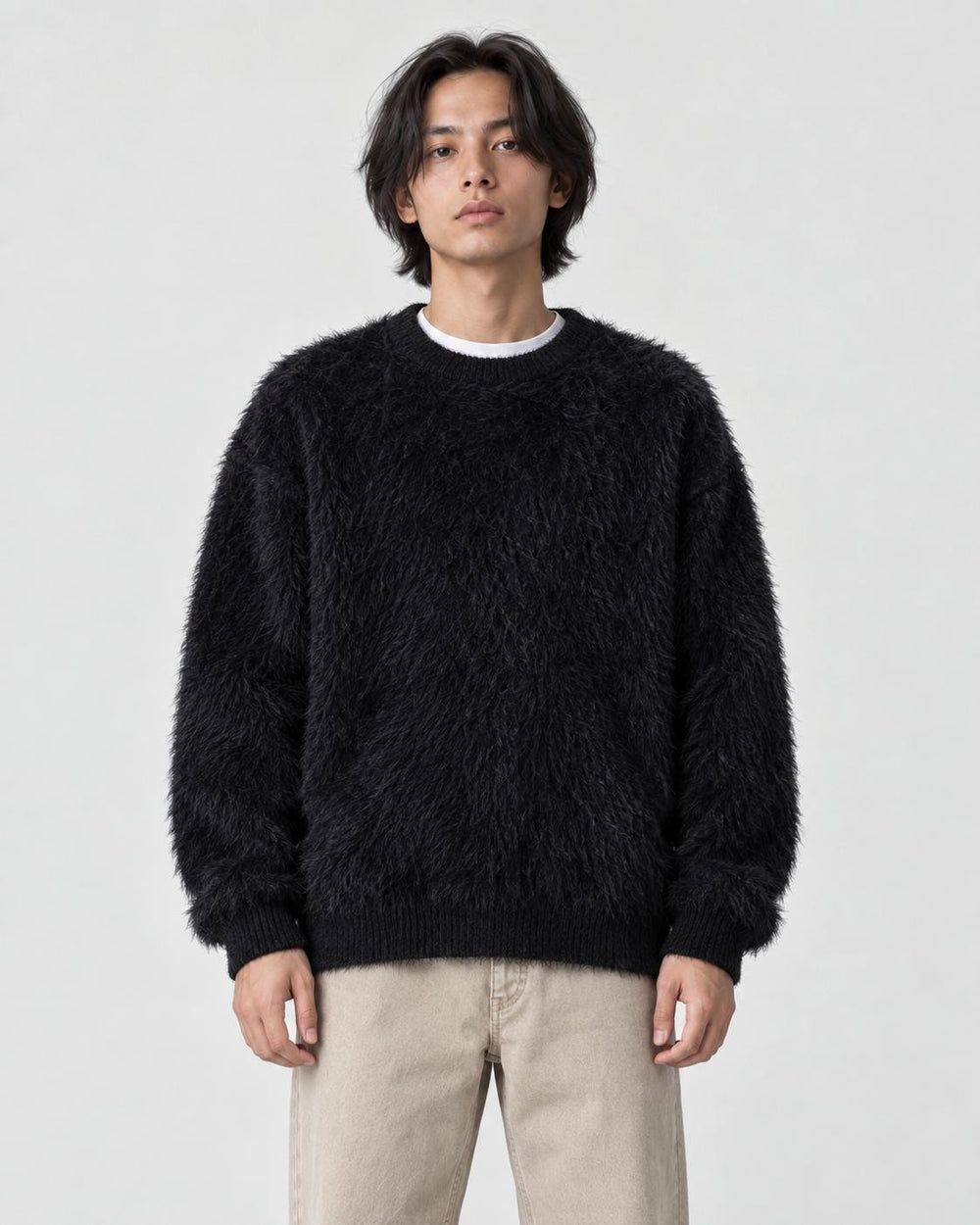 Model wearing the black shaggy knit crewneck sweater, front view