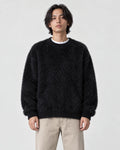Model wearing the black shaggy knit crewneck sweater, front view