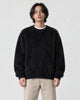 Model wearing the black shaggy knit crewneck sweater, front view