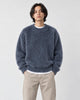 Model wearing the blue-gray shaggy knit sweater with dark jeans, front view