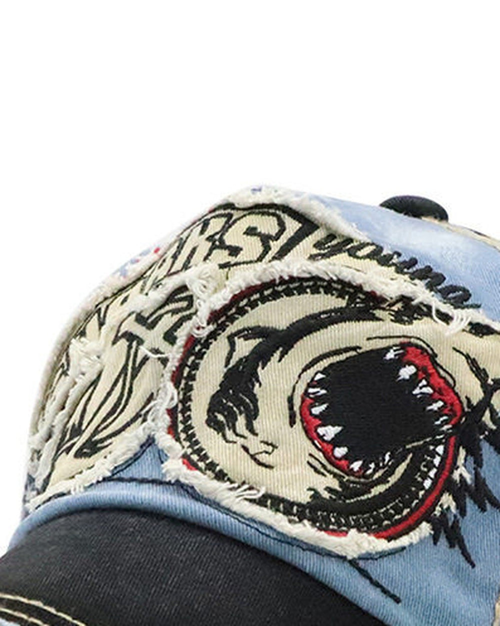 Close-up of the embroidered shark head with its open red mouth