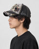 Model wearing the dark gray shark patch cap, side profile