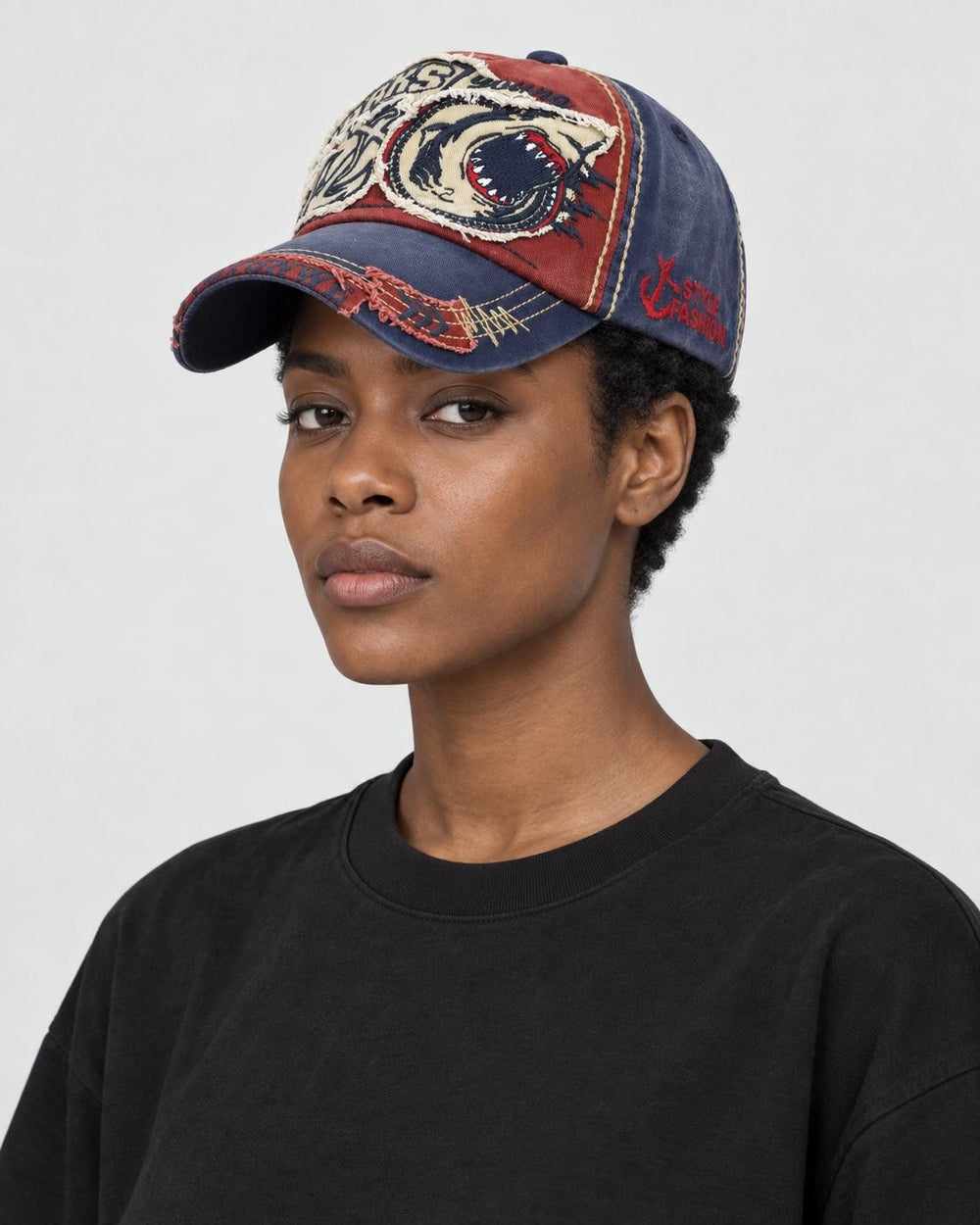 Model wearing the wine red shark patch cap, three-quarter view