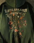 Close-up of the BEFEARLESS lettering and the flower-wrapped rib cage print