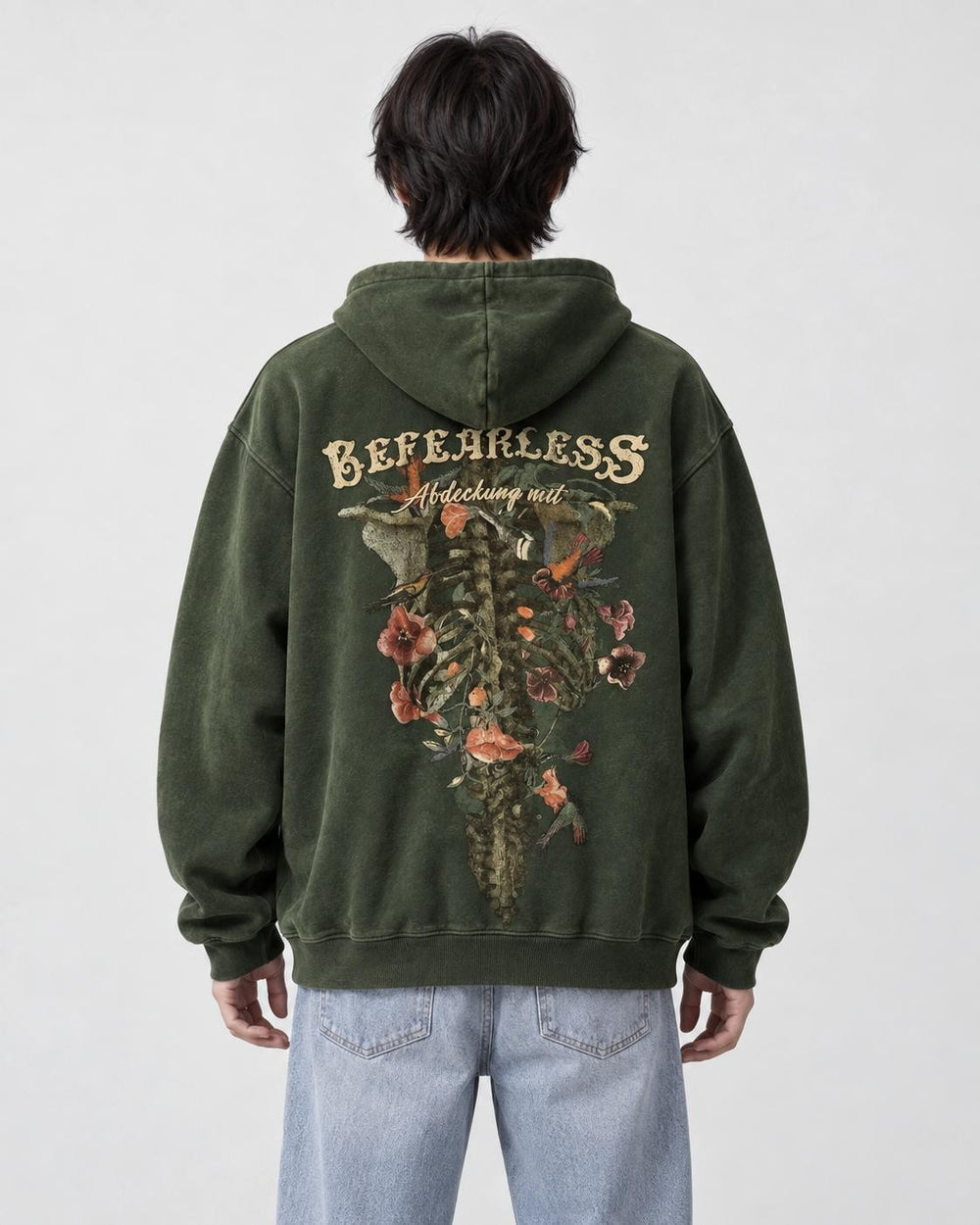 Model wearing the green skeleton flower hoodie with light-wash jeans, back view