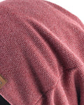 Close-up of the honeycomb-textured knit on the dusty red beanie