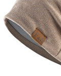Close-up of the tan leather-look F&S patch and the textured knit on the khaki beanie
