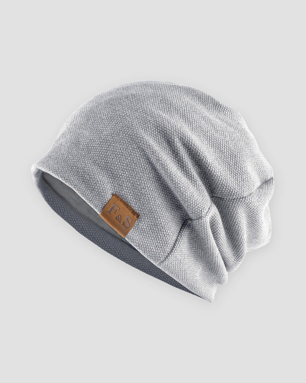 Light gray slouch beanie with a small tan F&S patch on the side