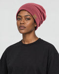Model wearing the dusty red slouch beanie with a black tee, side view