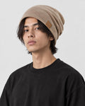 Model wearing the khaki slouch beanie with a black tee, three-quarter view