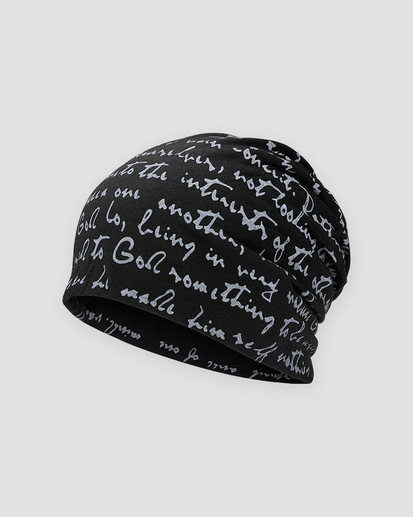 Black slouchy beanie printed all over with white handwritten cursive script