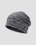 Dark gray slouchy beanie printed all over with black handwritten cursive script