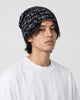 Man wearing the black script-print slouchy beanie, three-quarter view