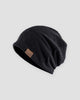Black slouchy textured knit beanie with a brown patch on the side
