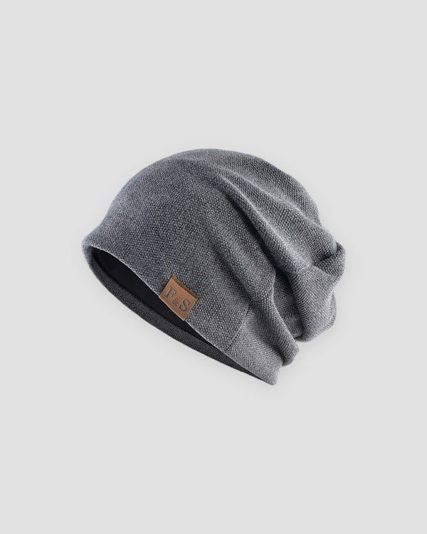Dark gray slouchy textured knit beanie with a brown PU leather patch