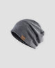 Dark gray slouchy textured knit beanie with a brown PU leather patch