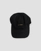 Black baseball cap with a small light gray whale embroidered at the front center