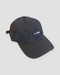 Dark gray baseball cap with a small white whale embroidered at the front center