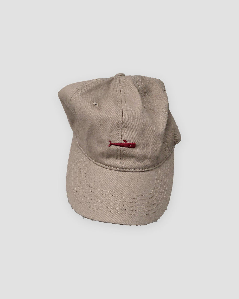 Khaki baseball cap with a small red whale embroidered at the front center