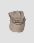 Khaki baseball cap with a small red whale embroidered at the front center
