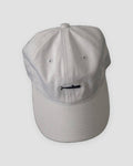 White baseball cap with a small black whale embroidered at the front center