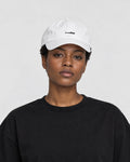 Model wearing the white whale cap with a black tee, side view