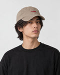 Model wearing the khaki whale cap with a black tee, three-quarter view