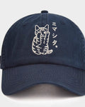 Front view of the navy cap with the white line-art cat and katakana on the crown