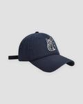 Navy baseball cap with a white embroidered seated cat and katakana, three-quarter view