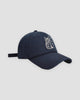 Navy baseball cap with a white embroidered seated cat and katakana, three-quarter view