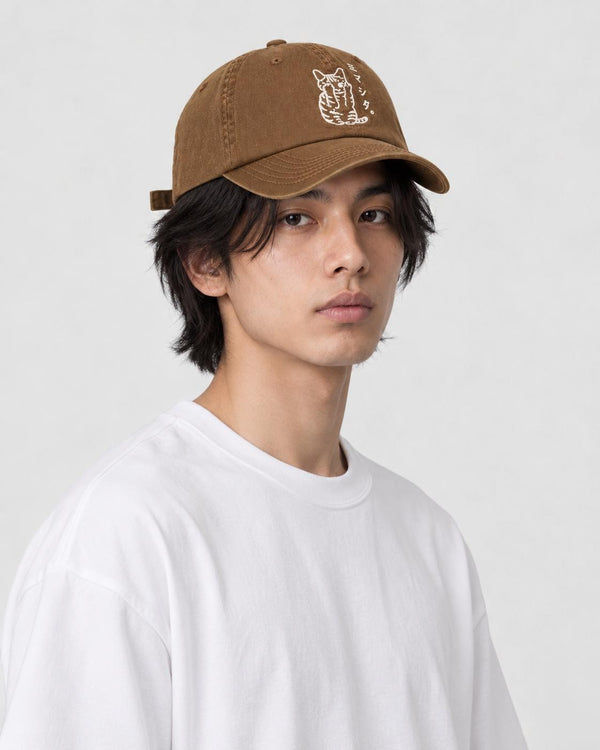 Man wearing the brown baseball cap with the white embroidered cat, three-quarter view