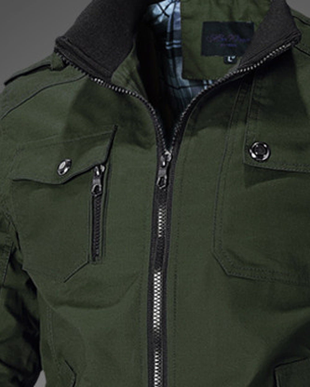 Close-up of the ribbed stand collar, epaulette, chest flap pocket and zip on the army green jacket