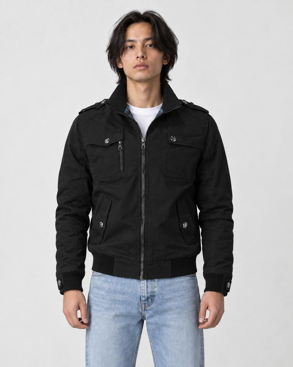 Model wearing the black field jacket zipped over a white tee and light-wash jeans, front view