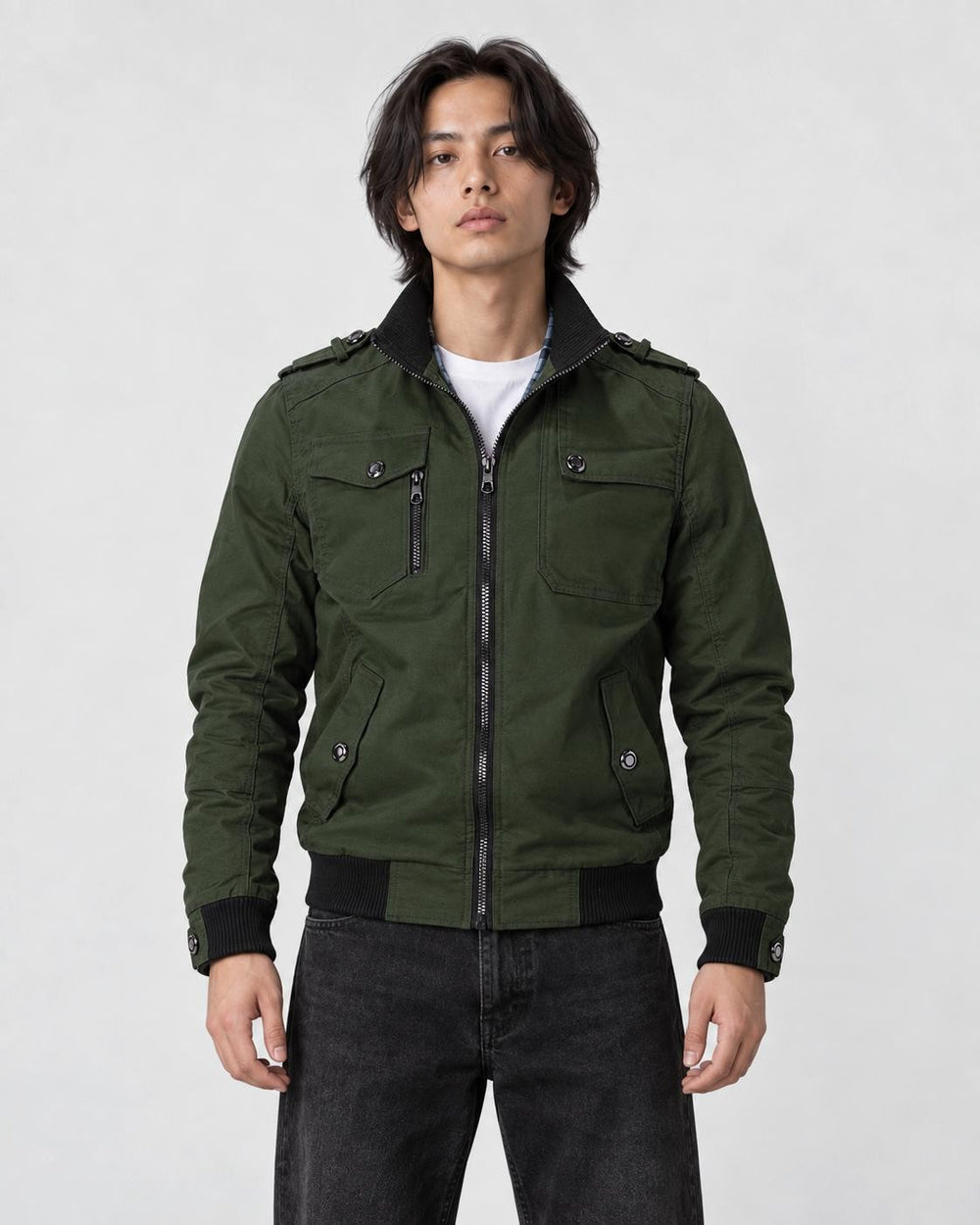 Model wearing the army green field jacket zipped over a white tee and black jeans, front view
