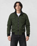 Model wearing the army green field jacket zipped over a white tee and black jeans, front view