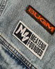 Close-up of the orange BUGM label and MEATEND FOUNDED patch on the chest