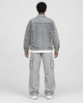 Model wearing the faded patch denim jacket, back view