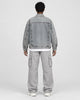 Model wearing the faded patch denim jacket, back view
