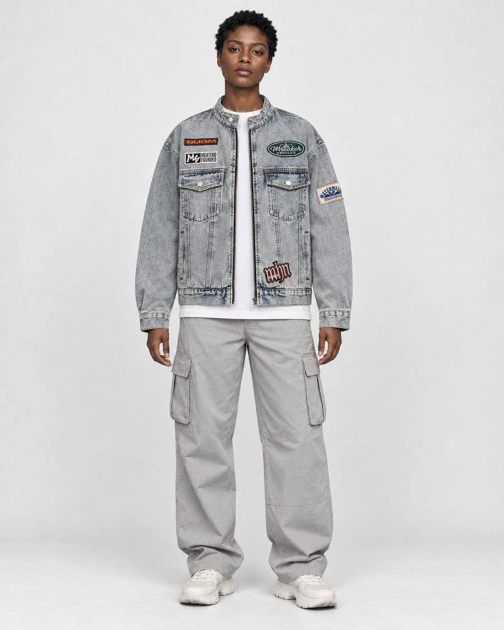 Model wearing the gray-blue patch denim jacket over a white tee, front view